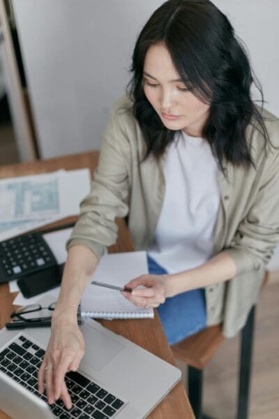 A person sitting at a desk organizing their finances through online banking and fintech tools.